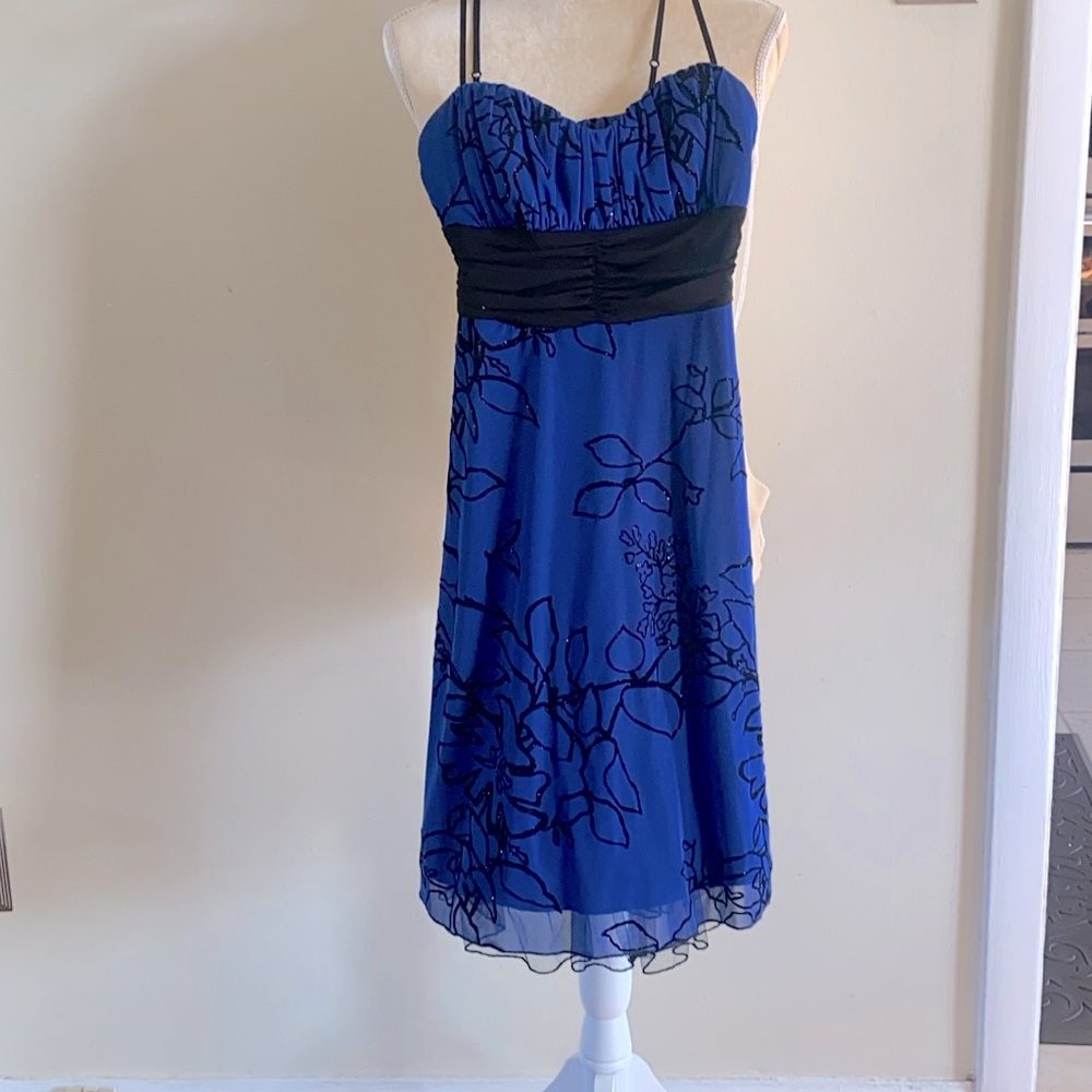 Blue and black speechless formal dress with sparkled flower pattern.